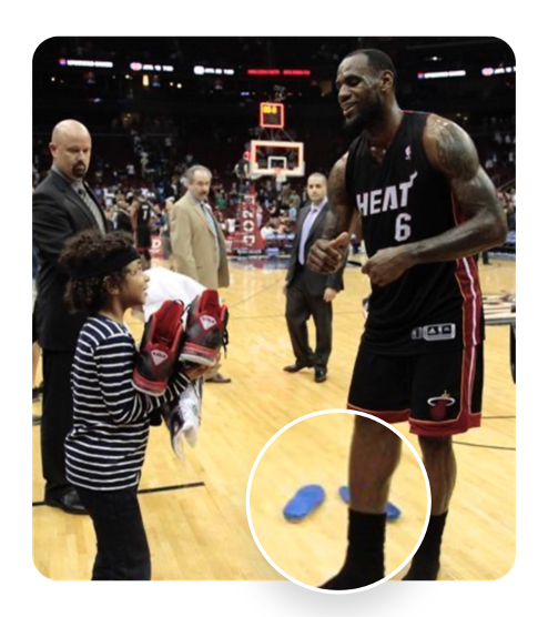 Lebron James giving a child his shoes without his insoles